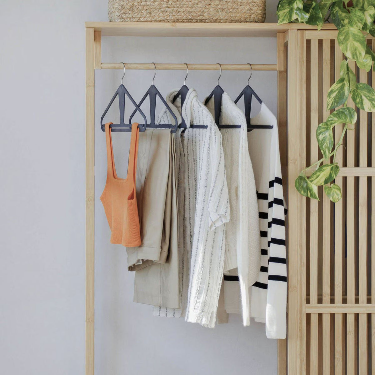 The Slim Kangaroo™ Hanger 40-Pack - Made in Wisconsin, USA with 100% recycled material - The patented design clips in pants, shirts, straps, tanks, jackets and even entire outfits on a single hanger