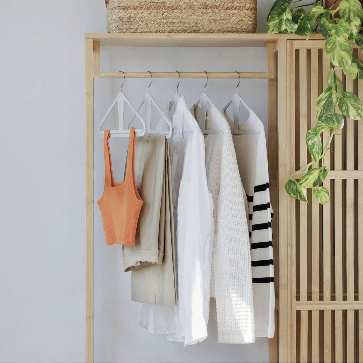 The Slim Kangaroo™ Hanger 40-Pack - Made in Wisconsin, USA with 100% recycled material - The patented design clips in pants, shirts, straps, tanks, jackets and even entire outfits on a single hanger